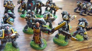 This sergeant is from Dark Vengeance. Next to him is a Rogue Trader plastic.